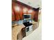 Well-lit kitchen with stainless steel appliances, granite countertops, and stylish backsplash at 9151 Bay Dr, Spring Hill, FL 34606