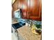 Close up view of the kitchen featuring granite counters, modern appliances and a decorative backsplash at 9151 Bay Dr, Spring Hill, FL 34606