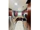 Modern kitchen with stainless steel appliances, dark cabinets, mosaic backsplash, and granite countertops at 9151 Bay Dr, Spring Hill, FL 34606