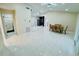 Open-concept living room featuring sleek tile floors, dining area, and views of other rooms at 9151 Bay Dr, Spring Hill, FL 34606