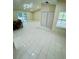 Spacious living room featuring pristine tile flooring, ample natural light, and an open layout at 9151 Bay Dr, Spring Hill, FL 34606