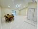 Spacious living room featuring pristine tile flooring, ample natural light, and an open layout at 9151 Bay Dr, Spring Hill, FL 34606