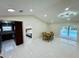 Open living area with dining table and access to bedroom, kitchen and pool at 9151 Bay Dr, Spring Hill, FL 34606