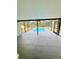 View of a screened-in pool with clear blue water and a ladder for easy access at 9151 Bay Dr, Spring Hill, FL 34606