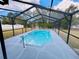Sparkling pool with a screened enclosure offers a private oasis for relaxation and enjoyment at 9151 Bay Dr, Spring Hill, FL 34606