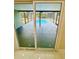 Screened patio features a pool with dark gray tile and a view from inside at 9151 Bay Dr, Spring Hill, FL 34606
