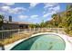 Backyard pool with a white fence and surrounding greenery at 5109 19Th W St, Bradenton, FL 34207