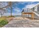 The backyard offers waterfront views, a deck, stairs to the main house and gravel landscaping at 6417 Driftwood Dr, Hudson, FL 34667