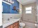 Tiled bathroom featuring vintage-inspired fixtures and decor at 6417 Driftwood Dr, Hudson, FL 34667