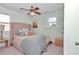 Cozy bedroom with neutral tones and natural light from the window at 6417 Driftwood Dr, Hudson, FL 34667