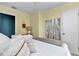 Neutral bedroom with a large modern art piece and bright, sunny ambiance at 6417 Driftwood Dr, Hudson, FL 34667