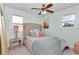 Bedroom with large windows, ceiling fan and carpet flooring at 6417 Driftwood Dr, Hudson, FL 34667