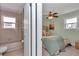 Ensuite bathroom and bedroom with ceiling fan and neutral decor at 6417 Driftwood Dr, Hudson, FL 34667