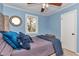 Cozy bedroom featuring blue walls, a comfortable bed, and a window with natural light at 6417 Driftwood Dr, Hudson, FL 34667