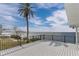 Wide angle shot of deck overlooking waterfront, with black metal guardrail and palm tree at 6417 Driftwood Dr, Hudson, FL 34667