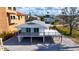Inviting exterior view of raised waterfront home with a spacious deck and gravel landscaping at 6417 Driftwood Dr, Hudson, FL 34667
