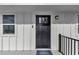 Charming front door with glass inserts and traditional hardware, complemented by a stylish blue welcome mat at 6417 Driftwood Dr, Hudson, FL 34667