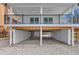 Spacious ground level parking with white columns, concrete floor, and white brick walls at 6417 Driftwood Dr, Hudson, FL 34667