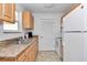 Functional kitchen equipped with wood cabinets, granite countertops and modern appliances at 6417 Driftwood Dr, Hudson, FL 34667