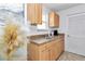 Well-lit kitchen with stainless steel sink and oak cabinets at 6417 Driftwood Dr, Hudson, FL 34667