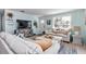 Cozy living room with light blue walls, comfortable seating, and a view of the water front at 6417 Driftwood Dr, Hudson, FL 34667