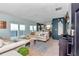 Bright living room with water views, a comfortable sofa, and stylish decor provides a serene and inviting space at 6417 Driftwood Dr, Hudson, FL 34667