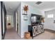 Cozy living area with stylish decor, a large TV, and a view towards an entryway at 6417 Driftwood Dr, Hudson, FL 34667