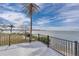 Waterfront patio with black railing offers stunning views of the bay and surrounding lush, tropical landscaping at 6417 Driftwood Dr, Hudson, FL 34667