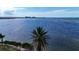Panoramic waterfront view with palm trees and clear skies at 6417 Driftwood Dr, Hudson, FL 34667