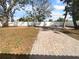 Spacious backyard featuring a brick pathway, lush trees and a privacy fence at 913 27Th E St, Bradenton, FL 34208