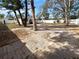 Large fenced backyard featuring mature trees and a brick paved area at 913 27Th E St, Bradenton, FL 34208