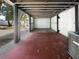 Covered carport featuring a metal roof and brick flooring at 913 27Th E St, Bradenton, FL 34208