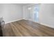 Neutral-toned empty room with wood floors and double doors to the outside at 913 27Th E St, Bradenton, FL 34208