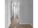 Well-lit hallway featuring multiple closets and doorways at 913 27Th E St, Bradenton, FL 34208