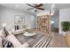 Bright living room with stylish striped rug, modern furniture, and built-in bookshelf at 913 27Th E St, Bradenton, FL 34208