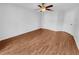 Clean and spacious bedroom with hardwood floors, ceiling fan, and closet at 4903 Rambling Rose Pl, Tampa, FL 33624