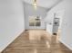 Dining room featuring hardwood floors, high ceilings, pendant lighting and pass through to the kitchen at 4903 Rambling Rose Pl, Tampa, FL 33624