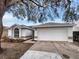 Charming single-story home featuring an attached two-car garage and neutral exterior paint at 4903 Rambling Rose Pl, Tampa, FL 33624