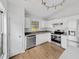 Kitchen featuring white cabinets, stainless steel appliances, stone countertops, and hardwood floors at 4903 Rambling Rose Pl, Tampa, FL 33624