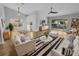 Bright living room with light wood floors, stylish furnishings, and sliding glass doors to the patio at 4903 Rambling Rose Pl, Tampa, FL 33624