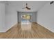 Living room featuring hardwood floors, ceiling fan, and glass sliding doors leading to the outdoor patio at 4903 Rambling Rose Pl, Tampa, FL 33624