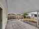 View of the home's screened patio with tile flooring that overlooks the fenced backyard at 4903 Rambling Rose Pl, Tampa, FL 33624