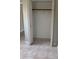 Empty closet space with neutral walls, simple shelving, and tiled floor at 814 20Th Sw St, Largo, FL 33770