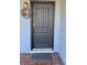 Close-up of a front door featuring a dark finish, traditional panel design, and welcoming wreath at 814 20Th Sw St, Largo, FL 33770