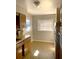 Compact kitchen featuring wooden cabinets, and a window over the sink with an adjacent refrigerator at 814 20Th Sw St, Largo, FL 33770