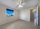 Cozy bedroom features tile floors, a ceiling fan and a double door closet for storage at 507 Circlewood Dr # O2, Venice, FL 34293