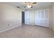 Neutral bedroom featuring tile floors, a ceiling fan and a double door closet for storage at 507 Circlewood Dr # O2, Venice, FL 34293