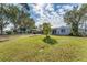 Expansive backyard featuring a lush lawn, mature trees, and a single story home at 5350 47Th N Ave, St Petersburg, FL 33709