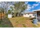 View of the spacious backyard with a storage shed and mature trees offers space and privacy at 5350 47Th N Ave, St Petersburg, FL 33709