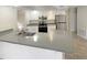 Kitchen featuring stainless steel appliances, white cabinetry, gray countertops, and a kitchen sink at 8379 Begonia St, Spring Hill, FL 34608